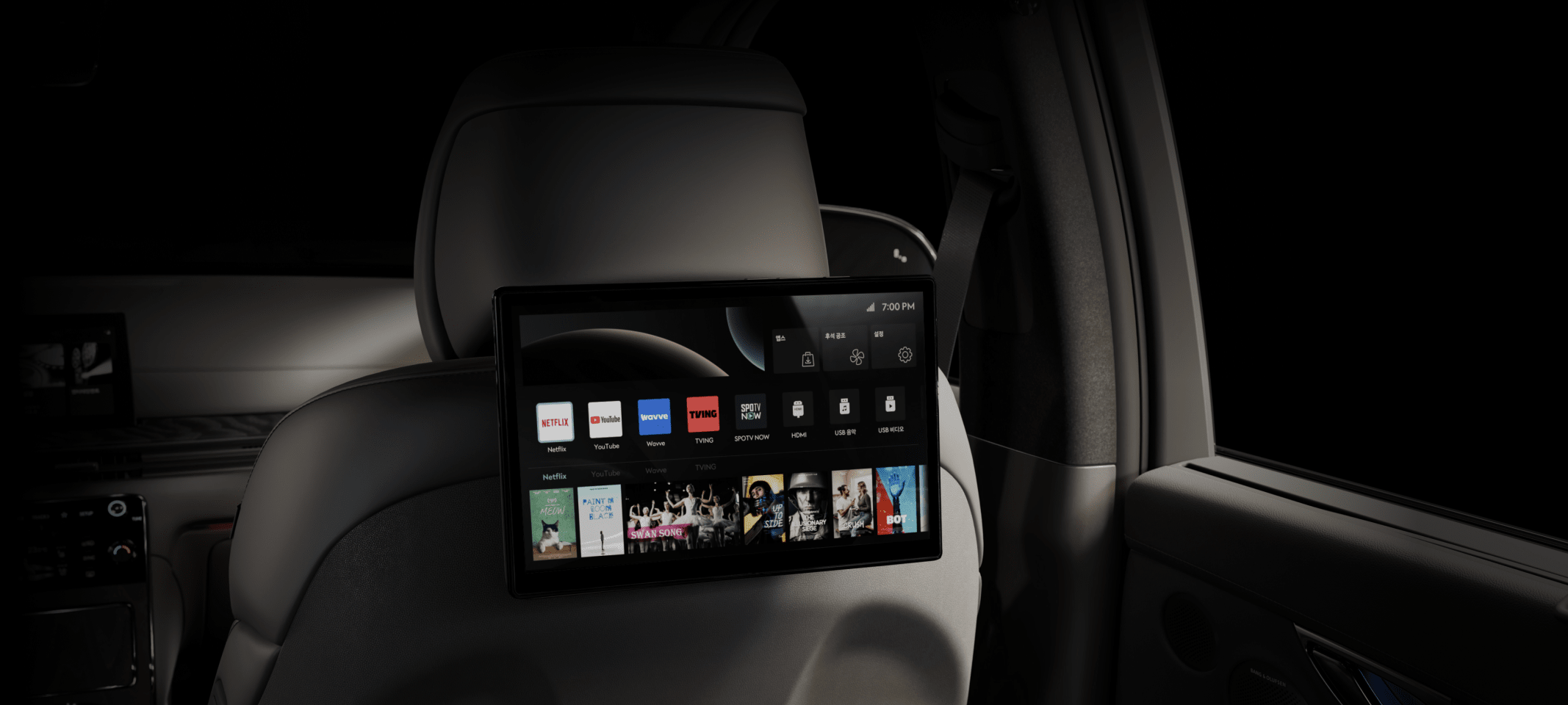 The display screen mounted behind the passenger seat headrest shows icons for streaming platforms like Netflix and YouTube.