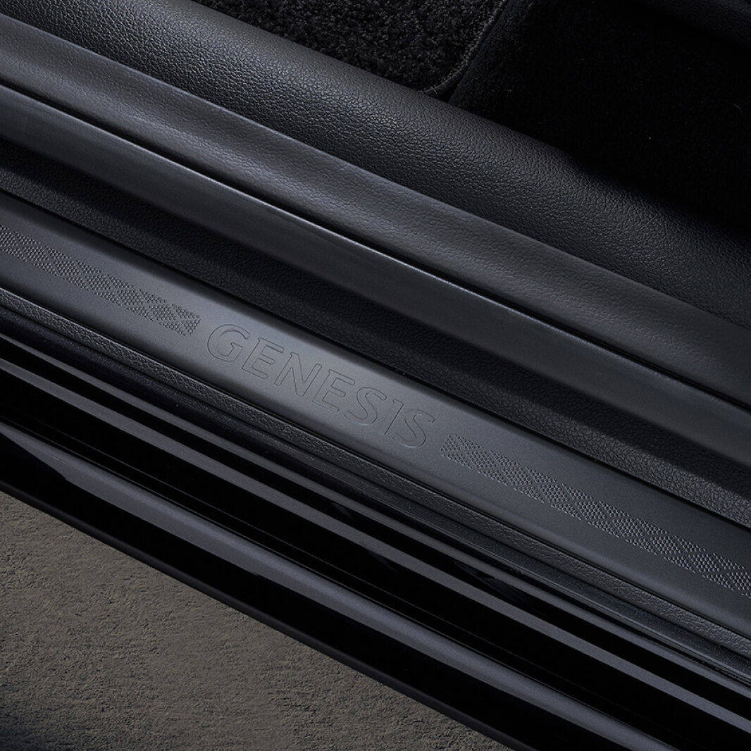 A black door sill engraved with 'GENESIS' is shown.