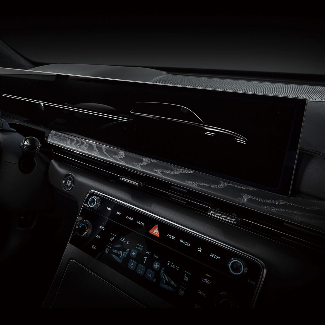 The center fascia, dominated by black, features a wide 27-inch display.