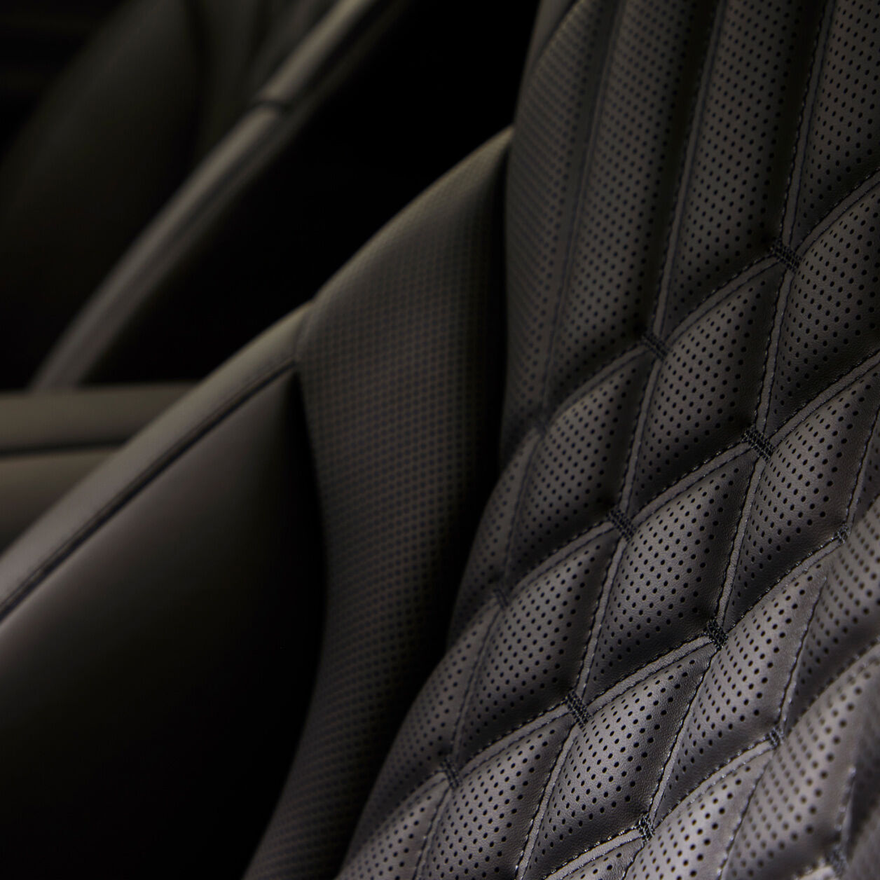 The quilted pattern of the black seats is emphasized.