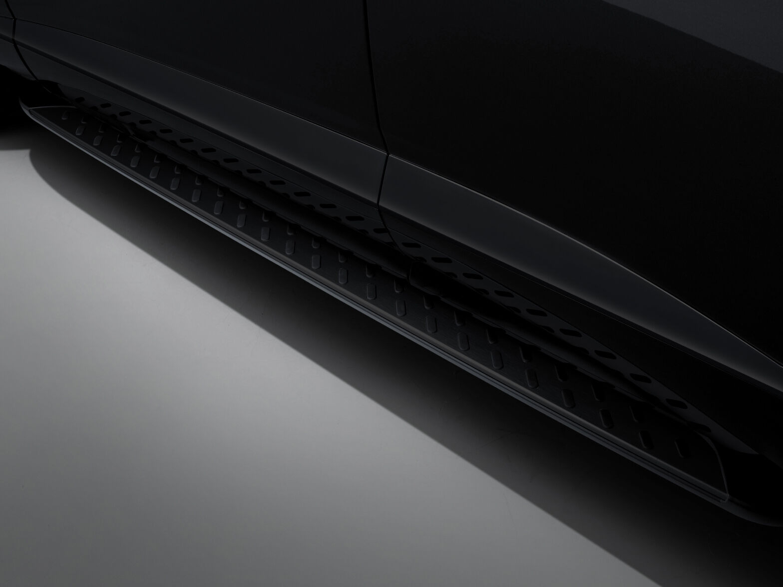 The door reveals detailed view of the slip-resistant pattern on the black colored footstep, which assists with vehicle entry.