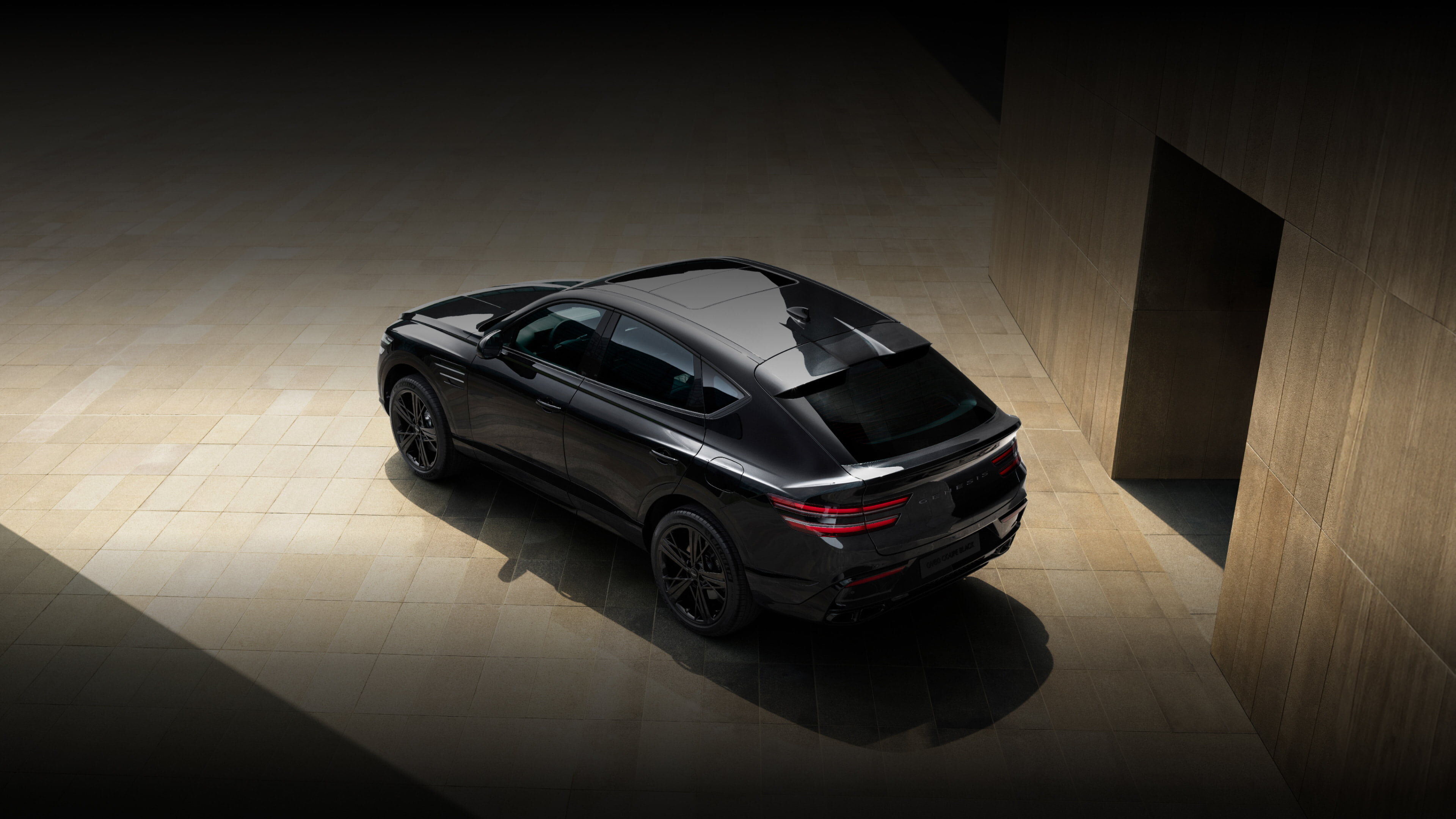 Scrolling further reveals a brown-tiled wall on the right and a central passage ahead.  In front of the passage, the GV80 Coupe Black is viewed from an upper rear angle.