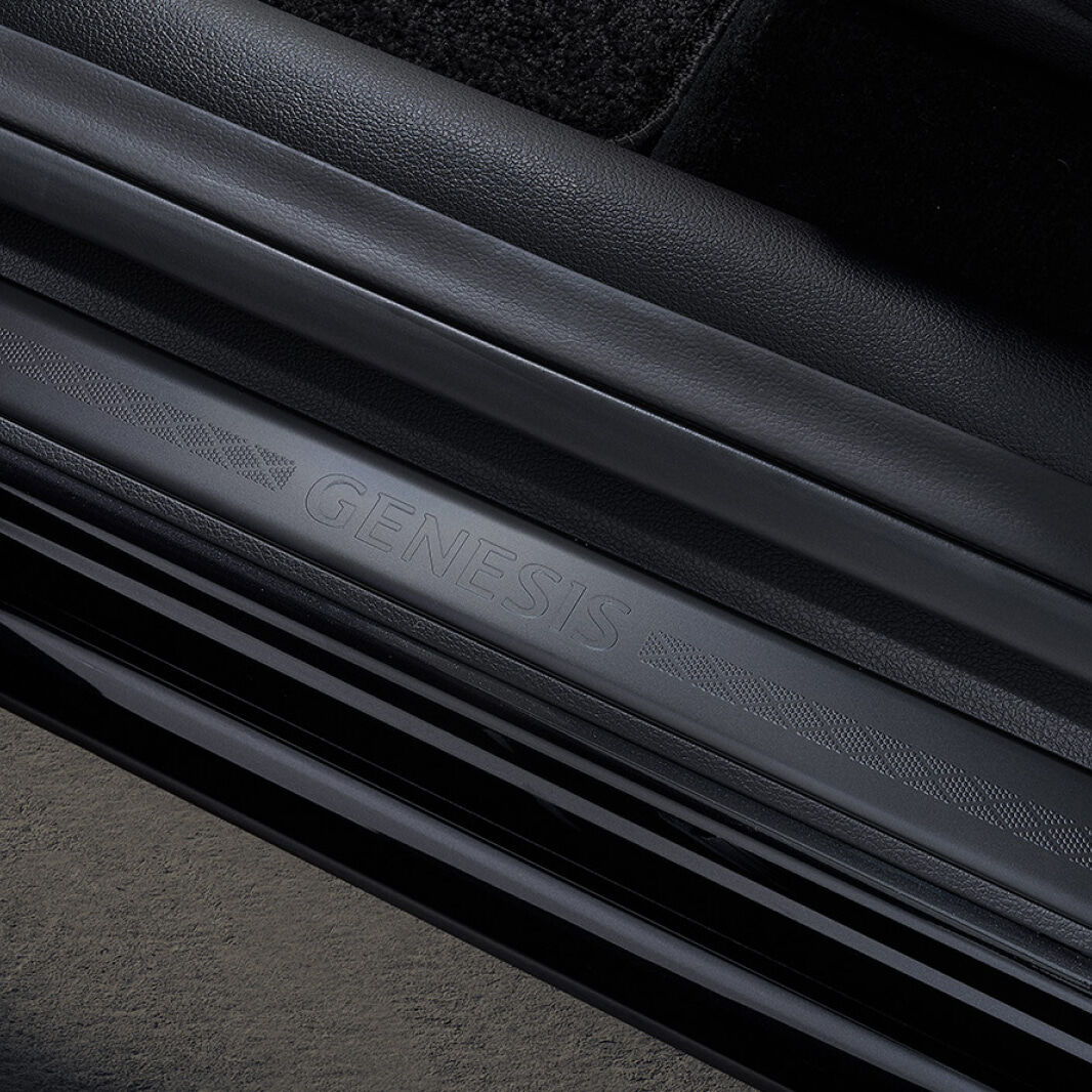 A black door sill engraved with 'GENESIS' is shown.