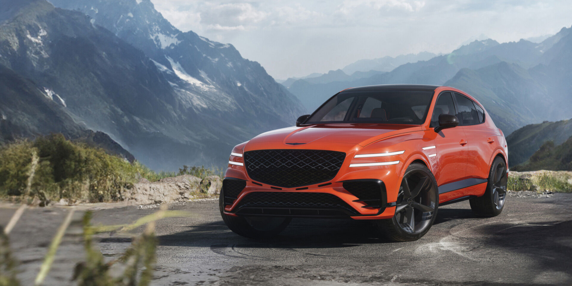 The GV80 Coupe Concept is parked on a racetrack, showing its side. The front and rear lights are brightly lit.