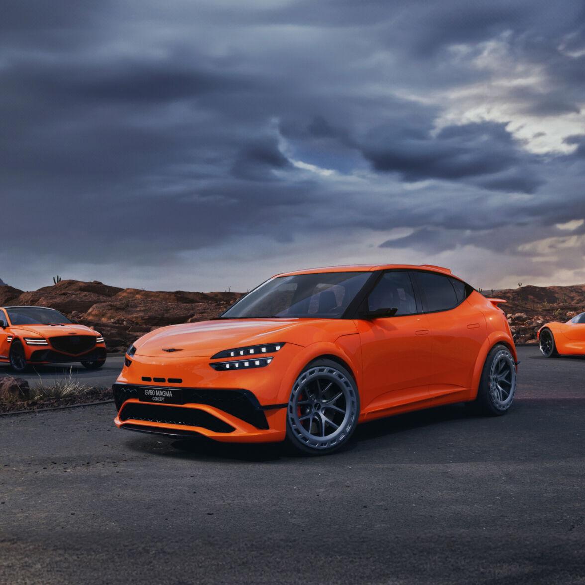 The Genesis GV60 Magma Concept, in a bold red-orange color, is parked diagonally in a dim outdoor setting with its front lights brightly on.