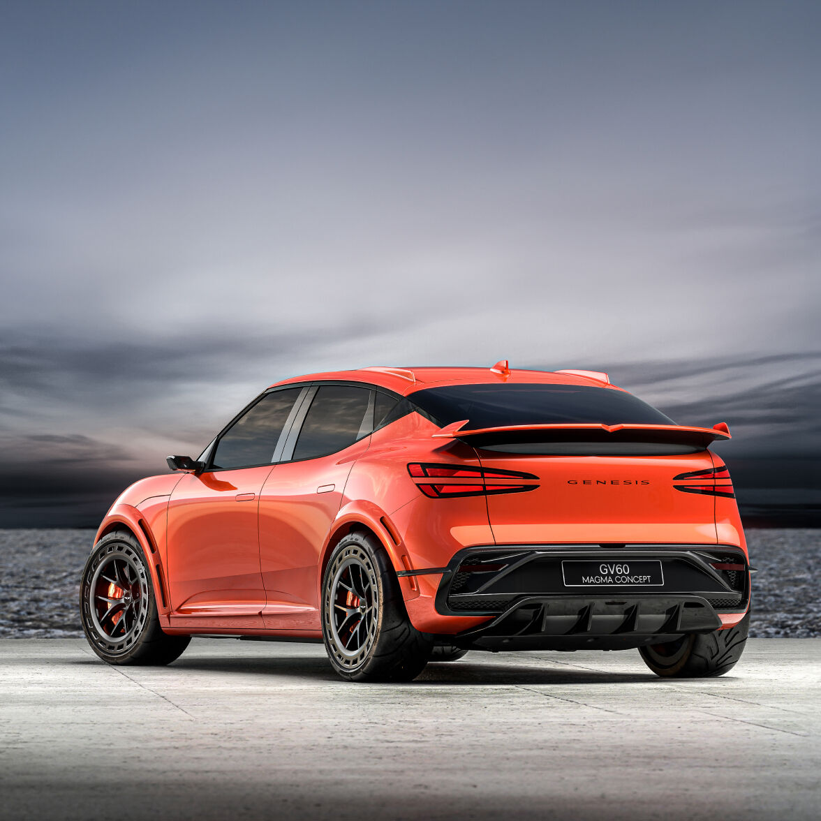 The GV60 Magma Concept is parked outdoors under a dim sky, showing its rear view. The two red rear lights are strikingly visible.
