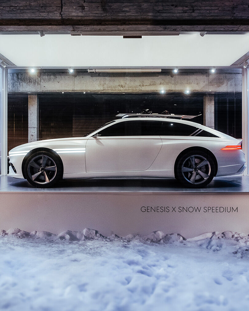 Genesis X Snow Speedium concept car is parked on top of a white pedestal.