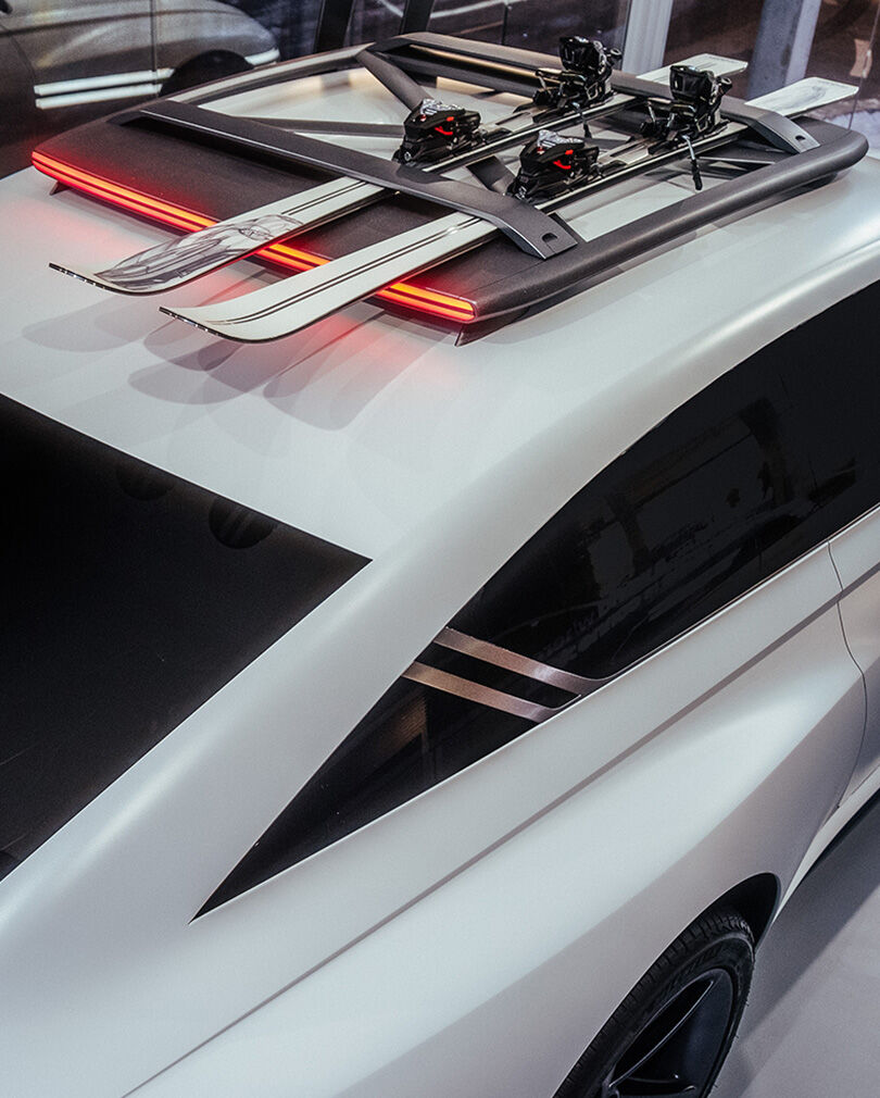 Skiis are atop the roof rack of the white-colored Genesis X Snow Speedium concept car.