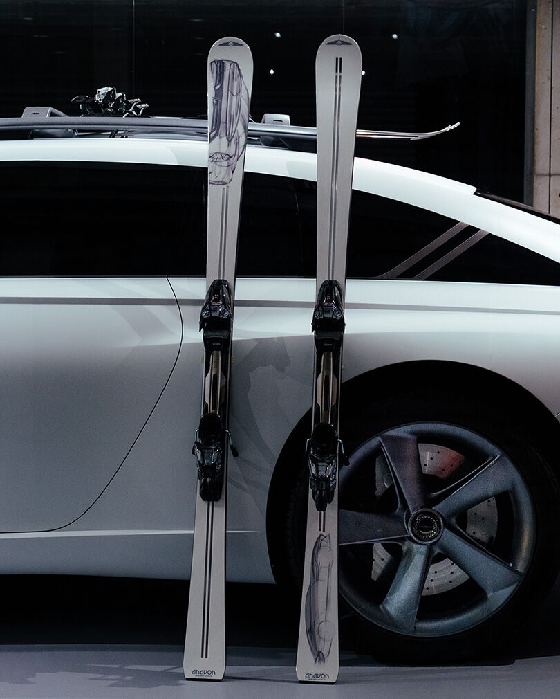 Genesis X Snow Speedium's rear wheels can be seen, with skiis placed on its side.