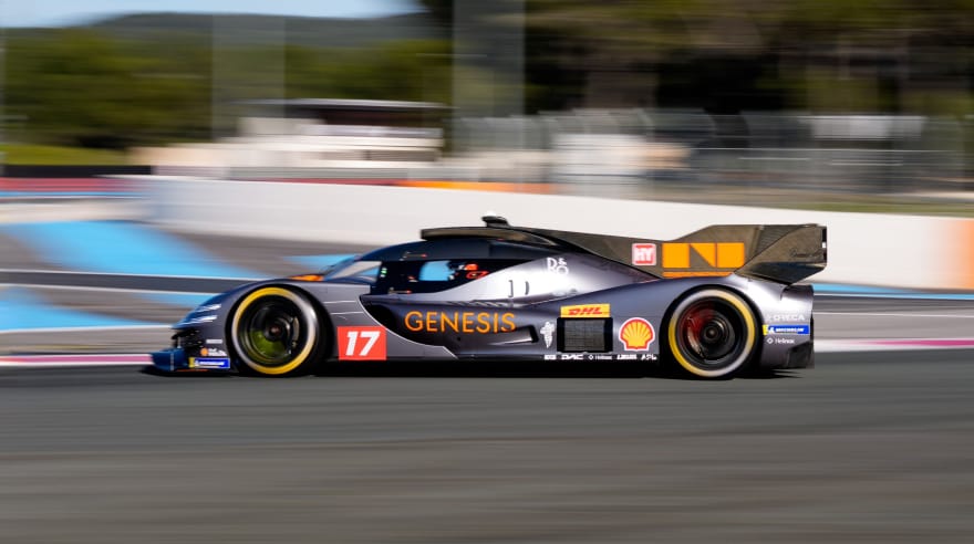 Side view of the GMR-001 hypercar racing on a circuit