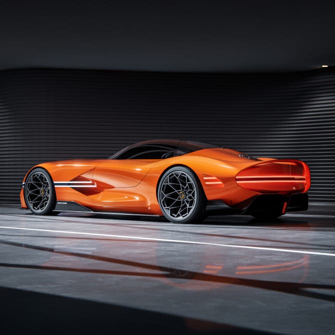 Side view of the X Gran Berlinetta Concept parked indoors with lights on