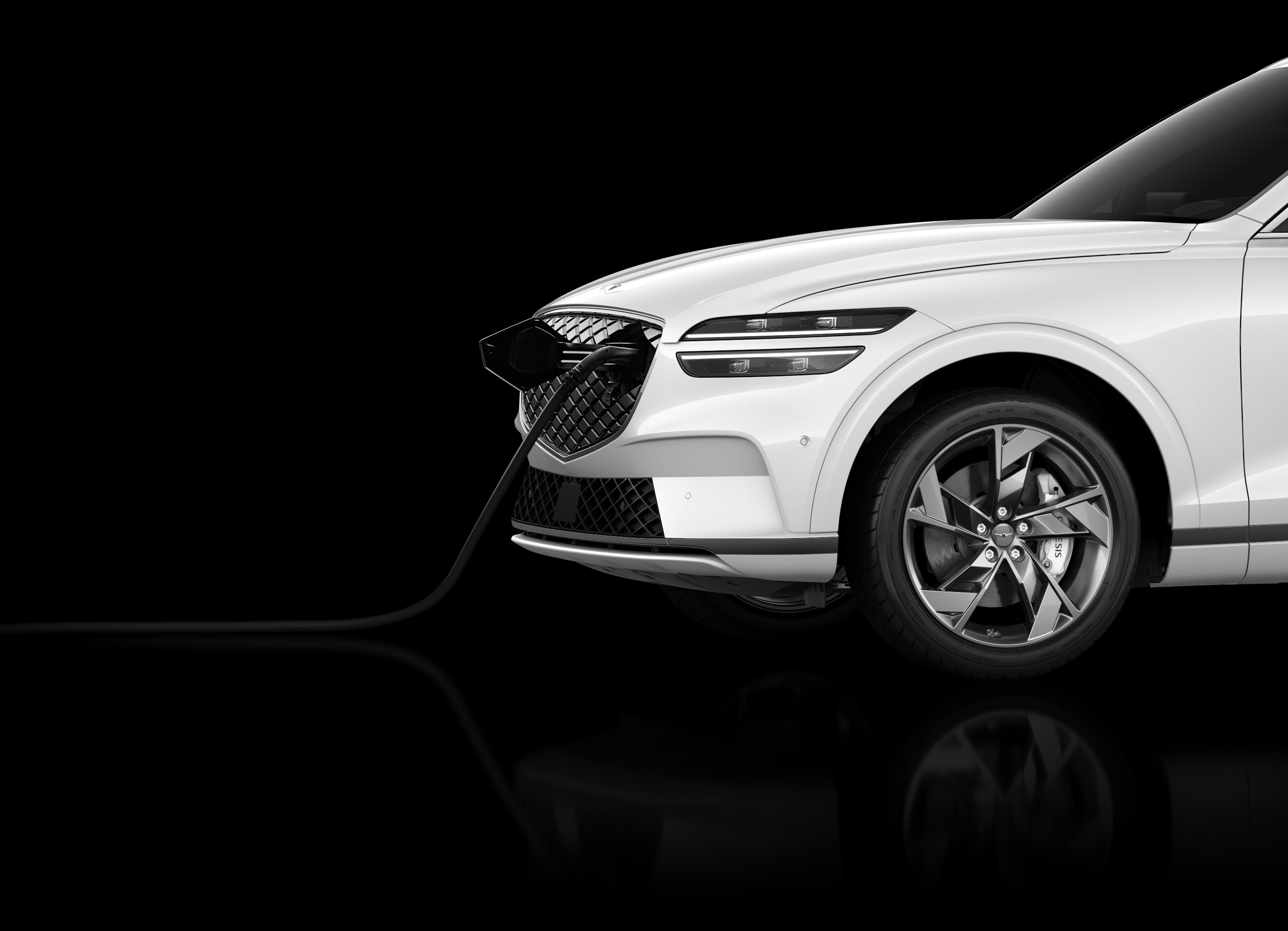 The white Electrified GV70 electronically charges against a black background. 