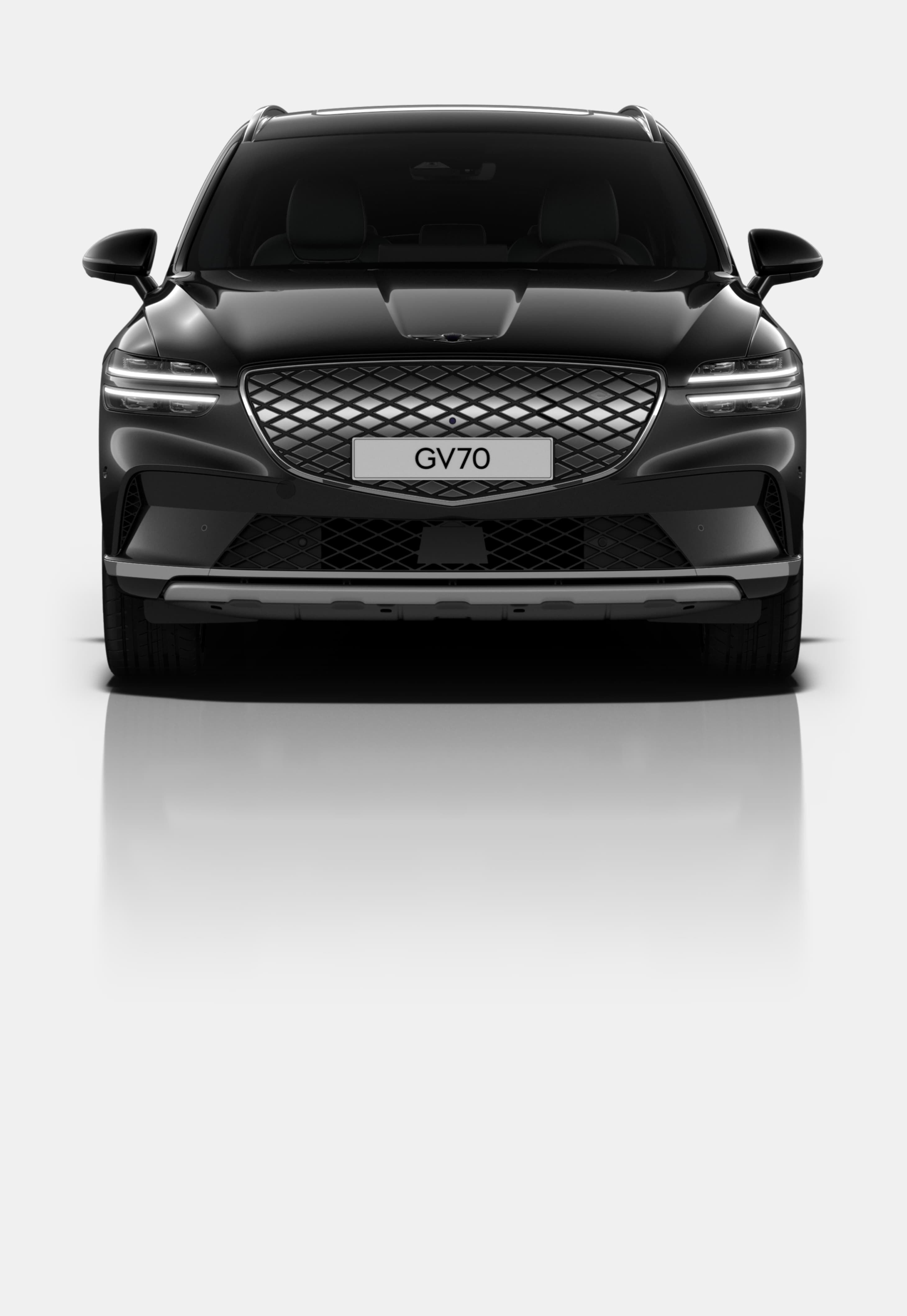 A front view of the Electrified GV70 with the Two-Line Quad Lamps lit up as the focal point. 