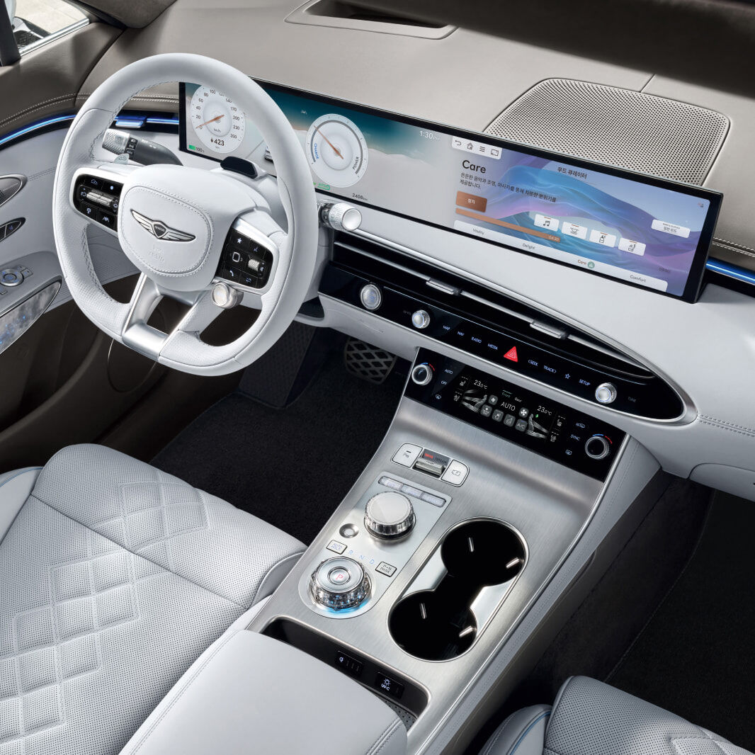 A view looking down at numerous function buttons by the driver's seat.