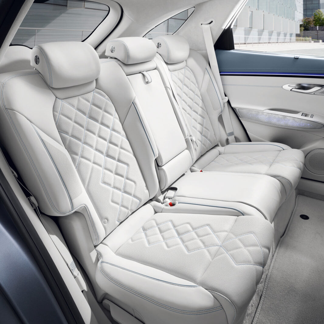 A view of the back seat from the open vehicle door. It has been neatly arranged.