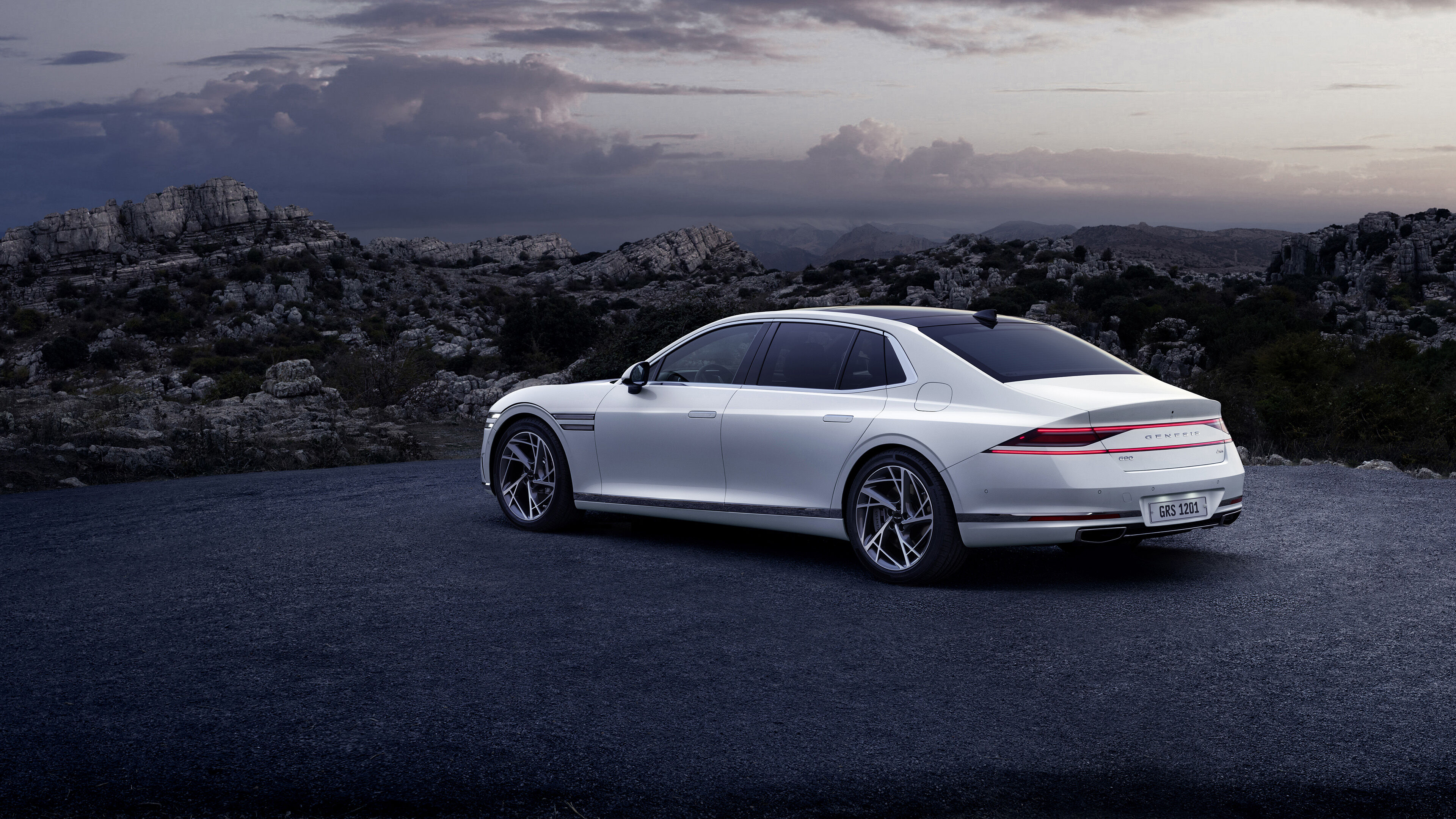 Rear end of Verbier White G90 seen overlooking a cliff.