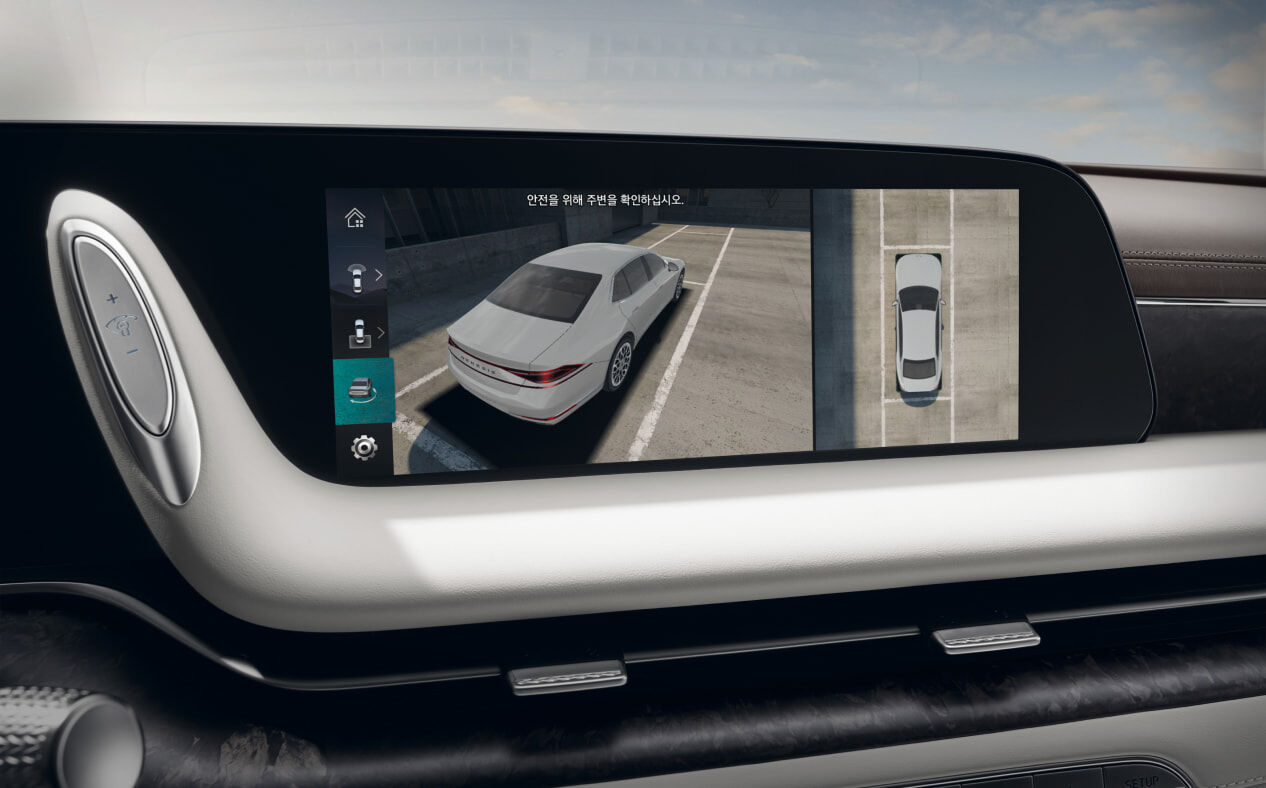 The area surrounding the vehicle is seen through the surround view monitor on the infotainment display in Glacier White interior.