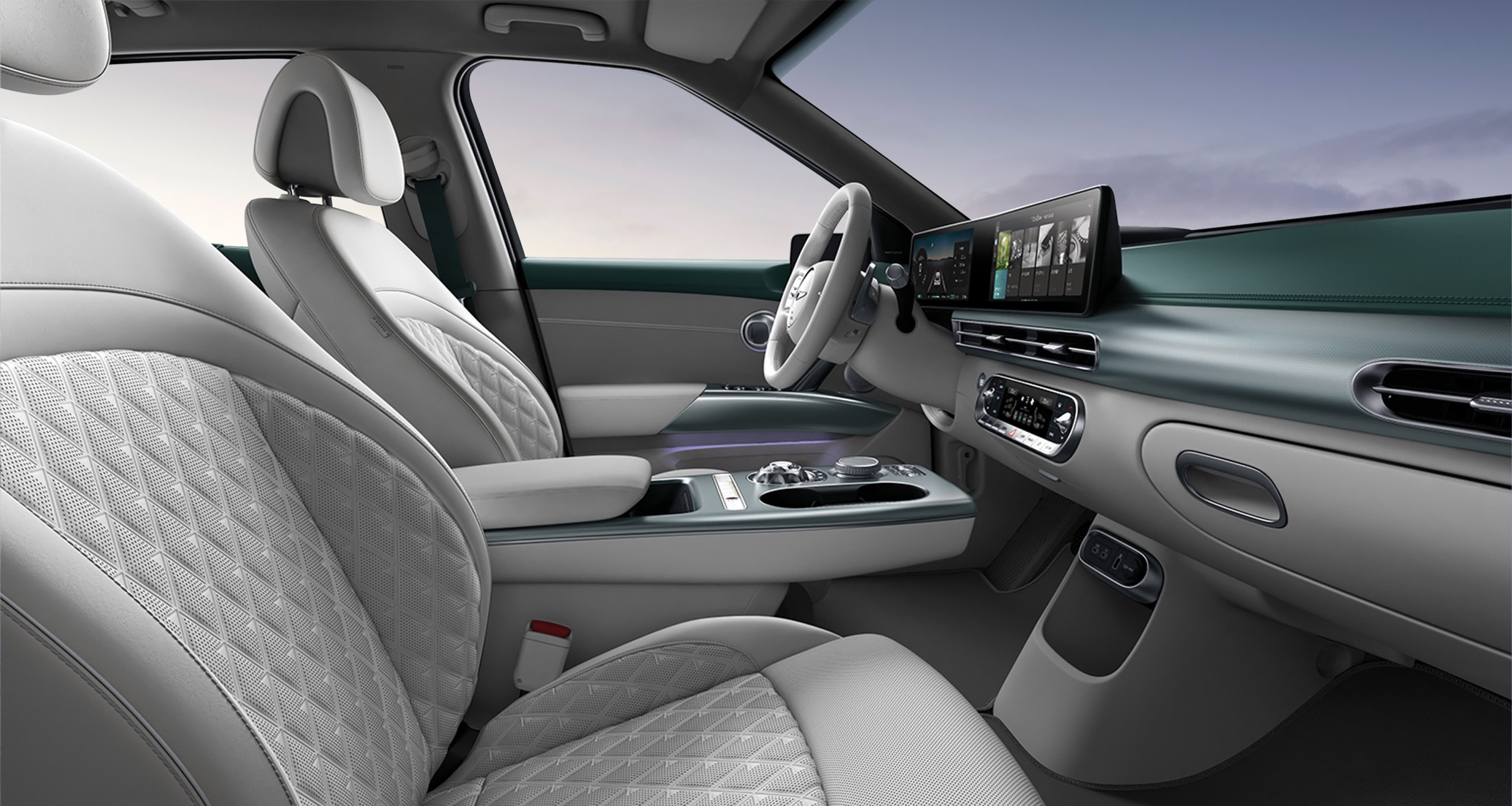 Looking at the driver's seat from the side of the passenger seat, GV60's interior in Monstera Green and Glacier White Two-tone.