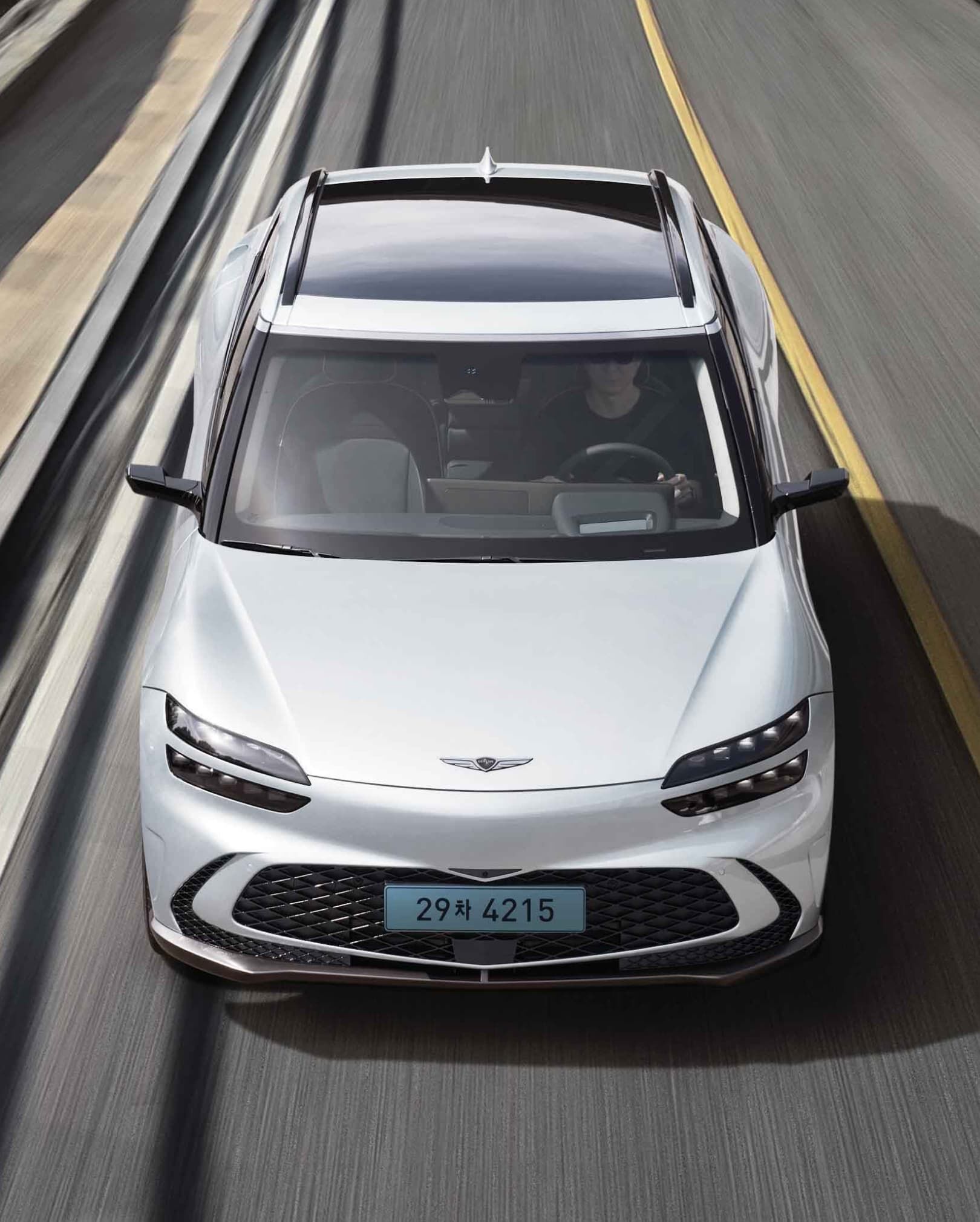 GV60 driving on the highway while maintaining its lane.