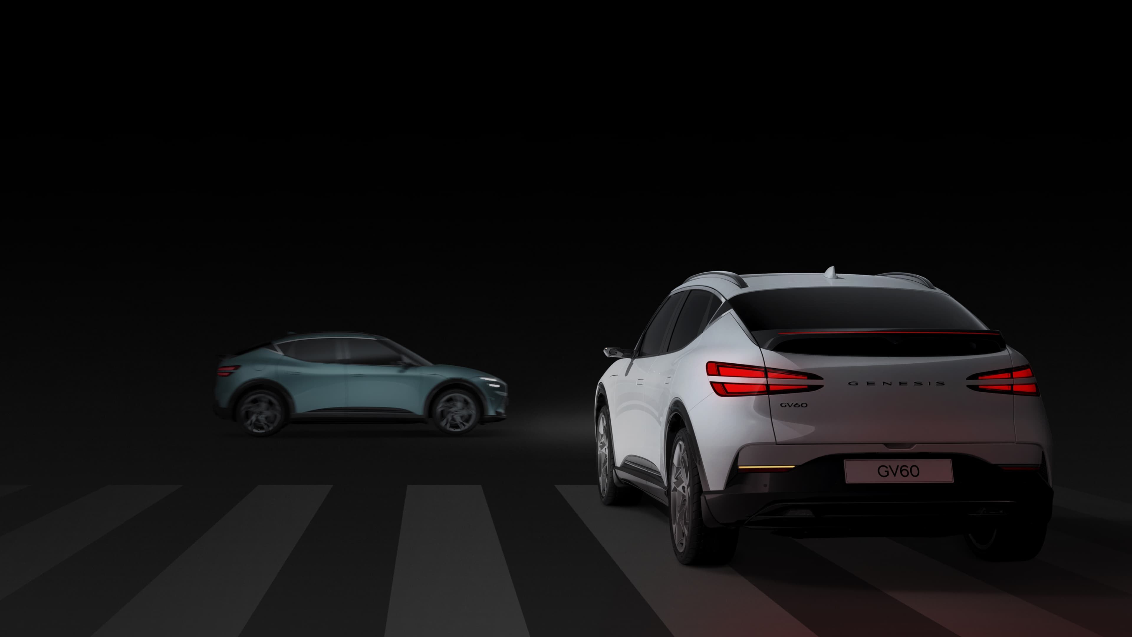 A Uyuni White GV60 car is turning left and a Hanauma Mint GV60 is going straight at an intersection.