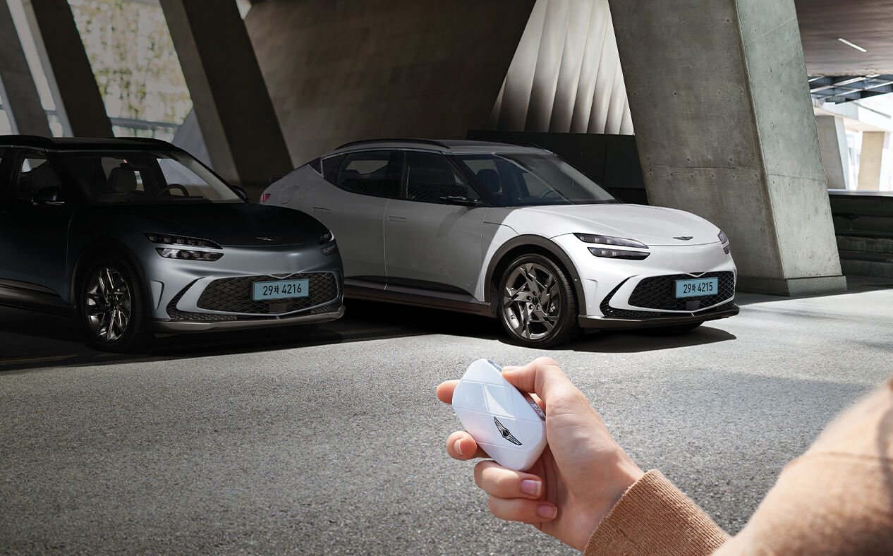 The car is being parked remotely using the smart key.