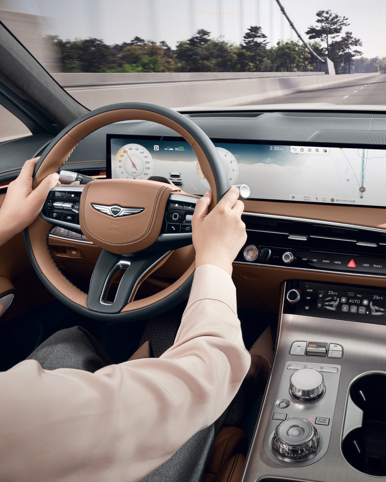 The driver is holding the steering wheel with both hands while driving.