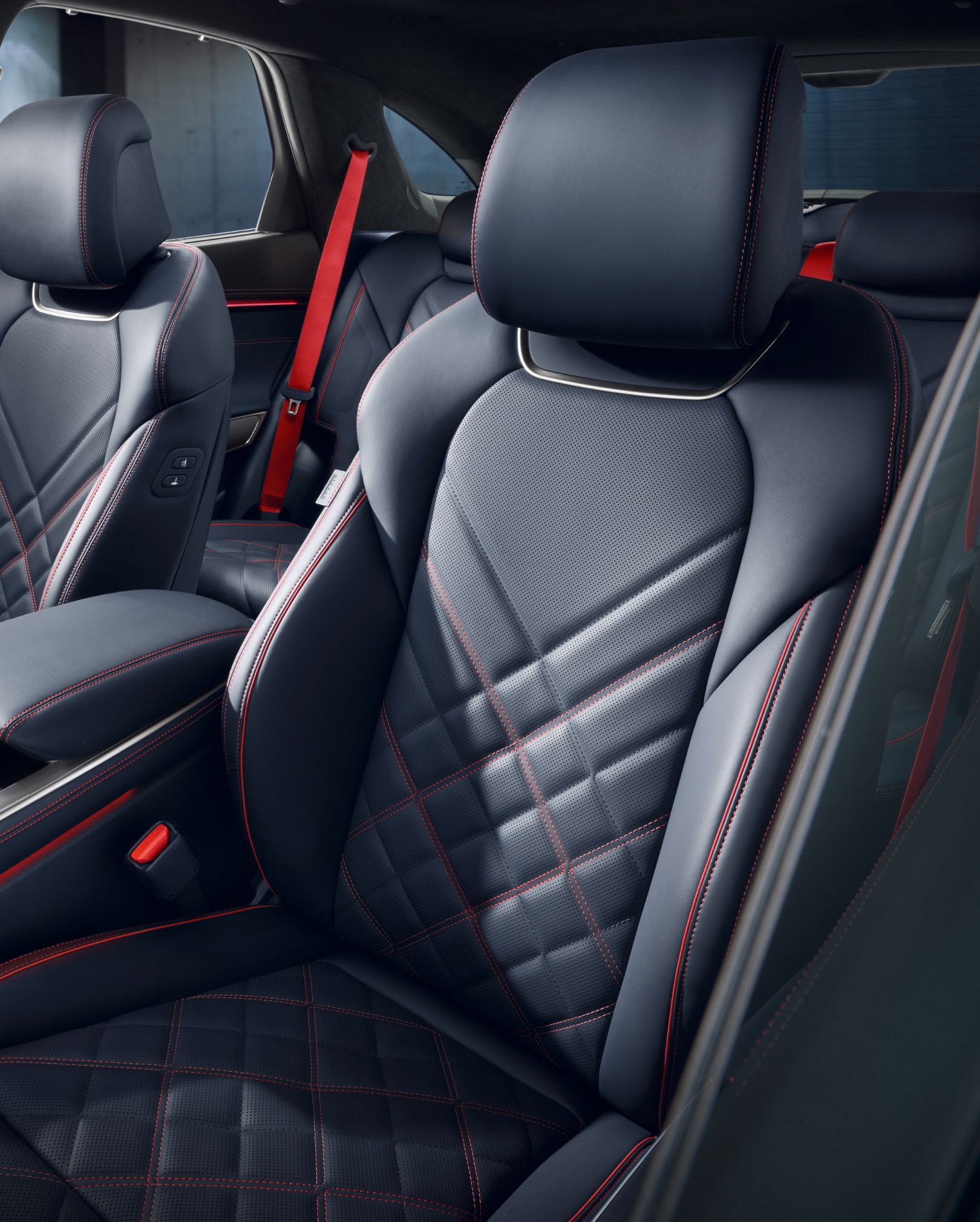 The orange stitching and black leather-designed seats of the  GV70 Sports Package are highlighted.