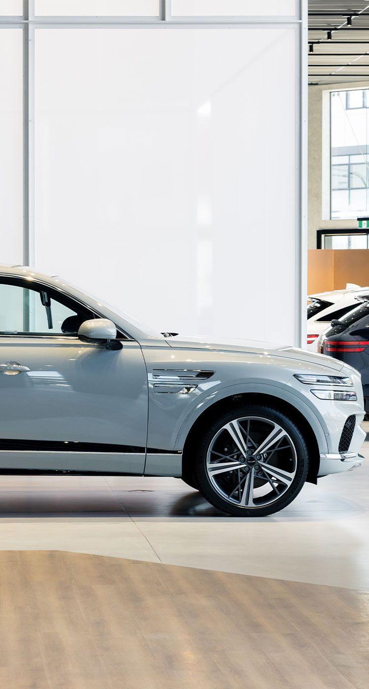 Genesis GV80 luxury SUV showcased in a refined showroom, highlighting elegant design, advanced engineering and premium comfort.