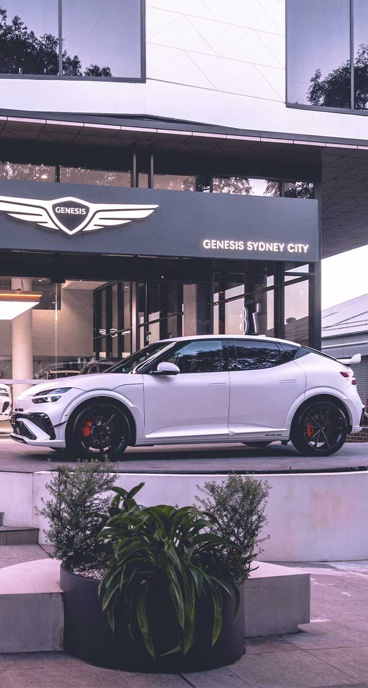 White Genesis vehicles displayed at Genesis Sydney City dealership, showcasing luxury design, premium craftsmanship and modern automotive innovation in a sophisticated showroom setting.