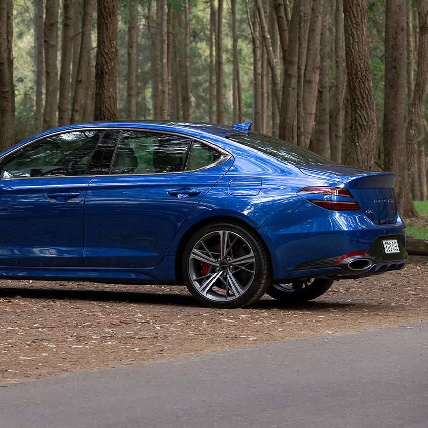 side profile of the genesis g70 parked on the road