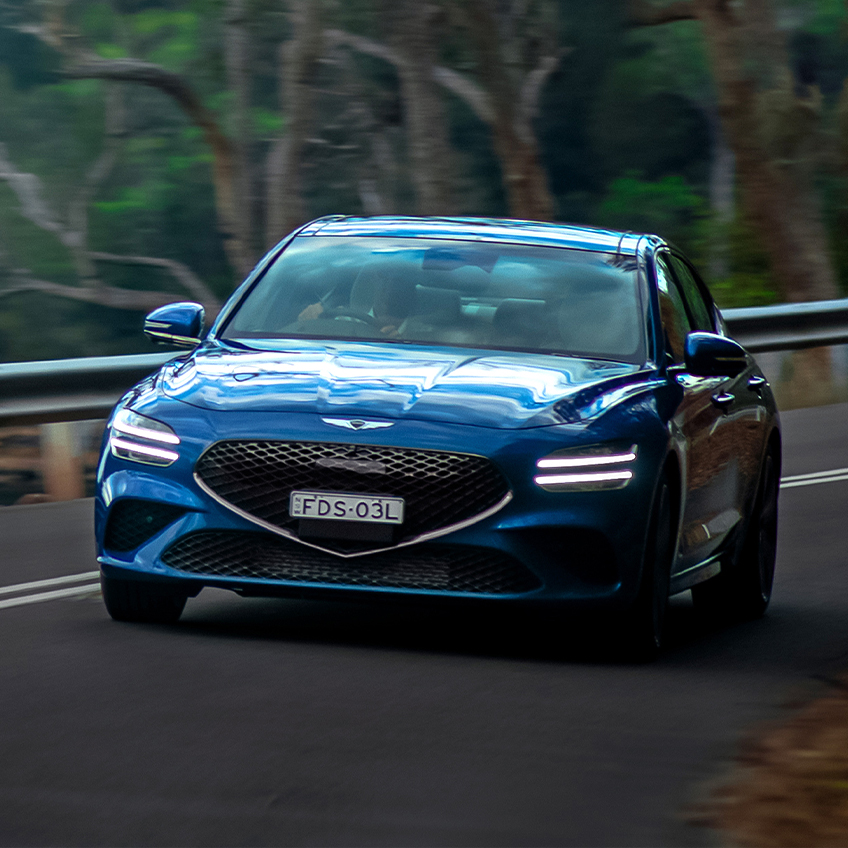 blue genesis g70 on the road