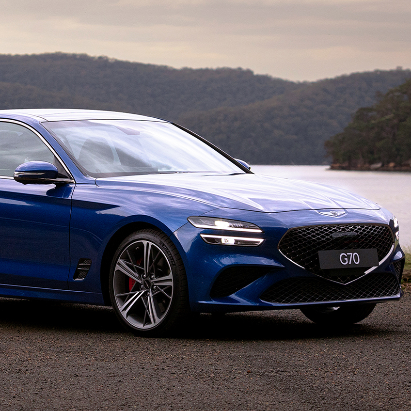 blue genesis g70 parked near the lake