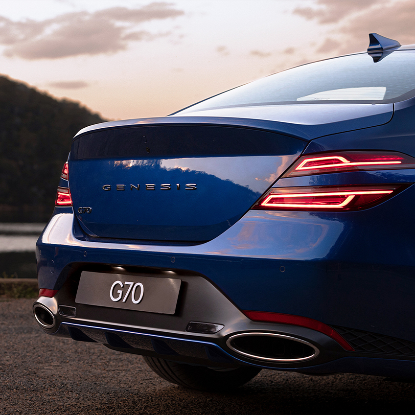 rear view of genesis g70 on a highway with focus on the tail lamps of the car