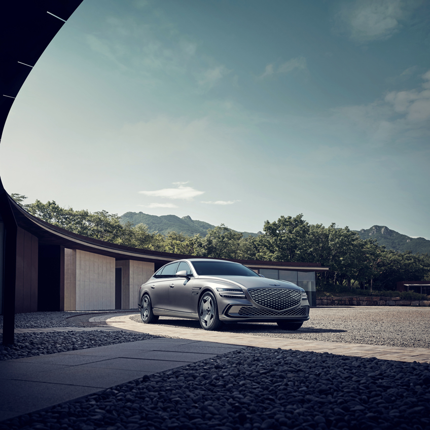 A rear shot of the Genesis G80 on the road.