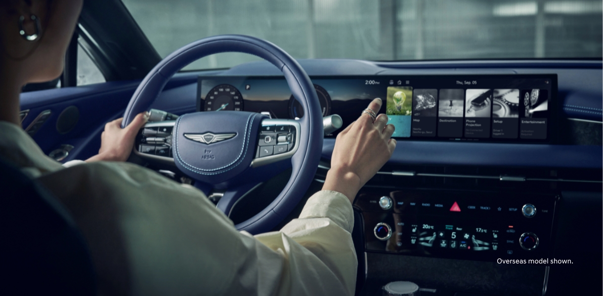 close up of g80-ev dashboard with odometer and a rear blind spot view of an approaching car of the vehicles right side