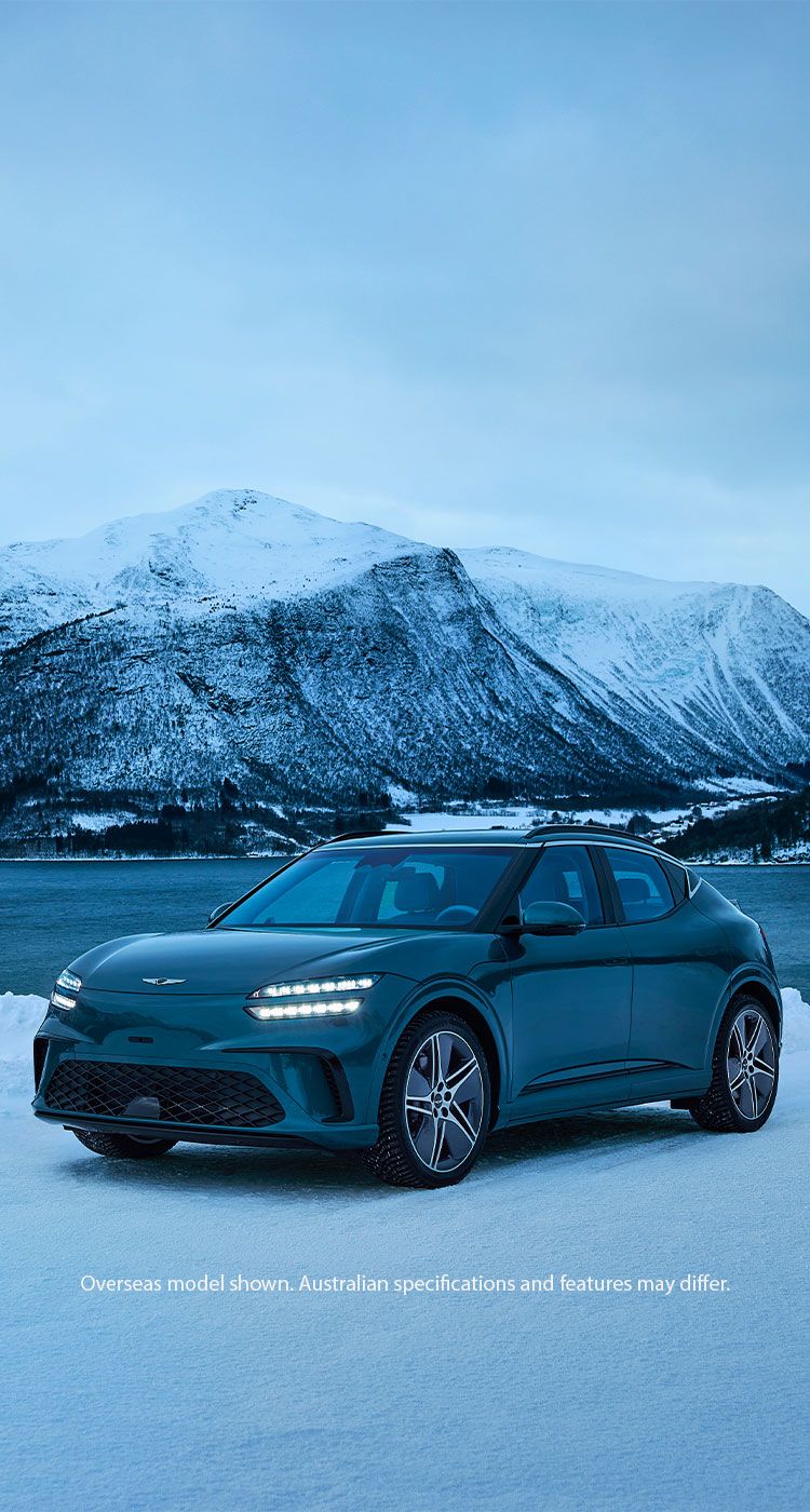 Genesis GV60 electric SUV showcased on a snowy lakeside with breathtaking mountain scenery, highlighting modern design, performance, and premium electric mobility.