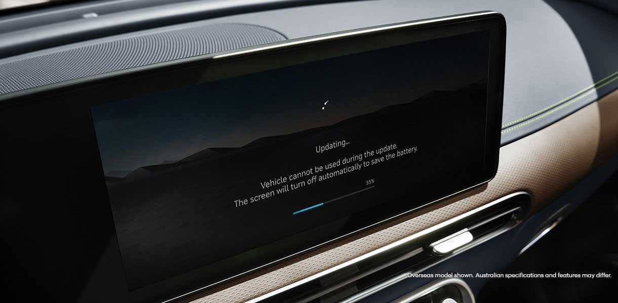 Genesis GV60 infotainment display showing an over-the-air software update progress screen within the premium vehicle interior.