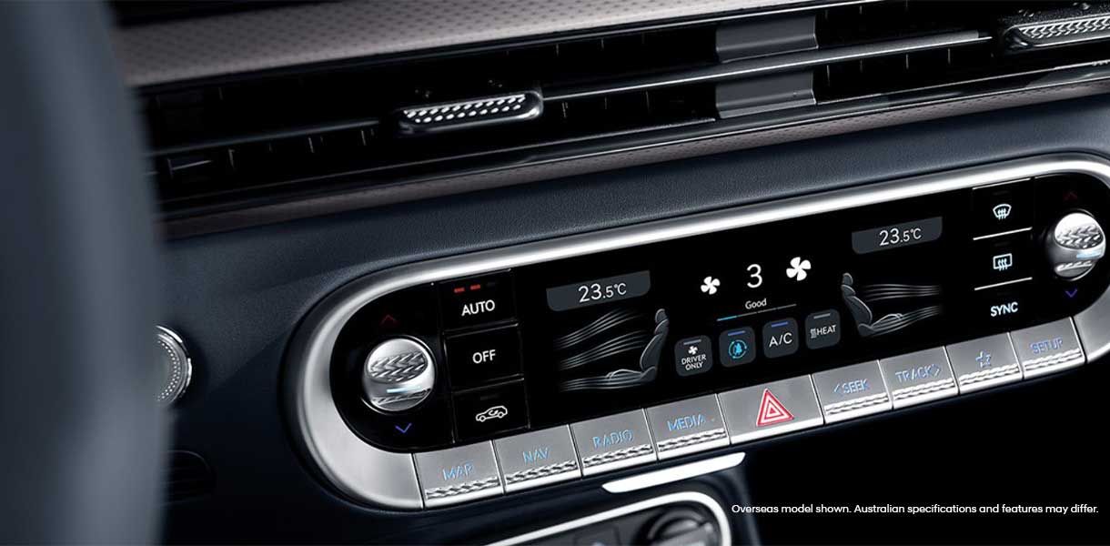 Genesis GV60 climate control panel displaying dual-zone temperature settings, airflow controls, and touchscreen air conditioning functions within the premium cabin interior.