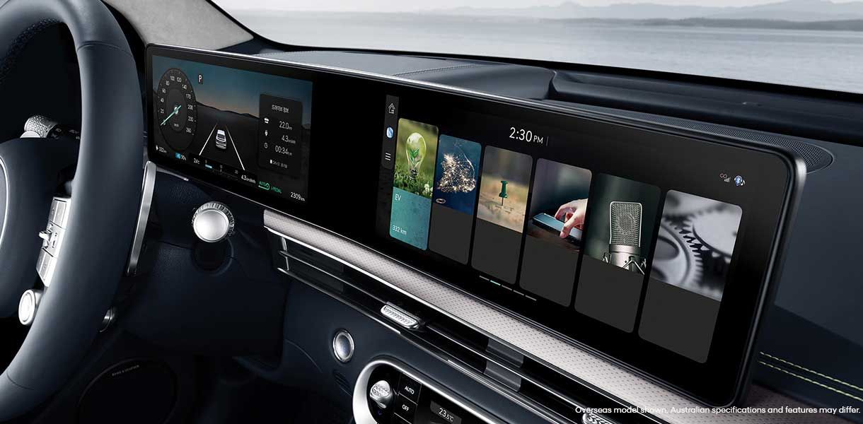 Genesis GV60 panoramic digital display showcasing the infotainment system, navigation, EV information, and multimedia controls within the premium cabin.