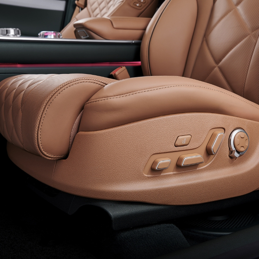 close up shot of front passenger seat dashboard and door, furnished with dark chocolate brown leather interior 