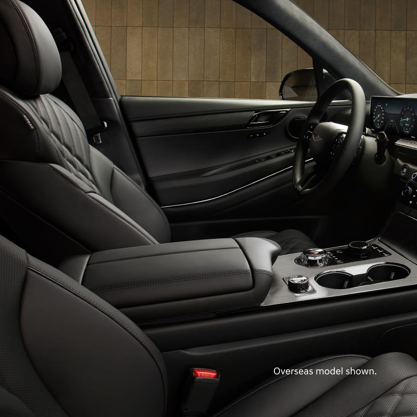 close up of gv80 silver terrain mode changing button which has: drive, push, terrain, etched onto the centre knob