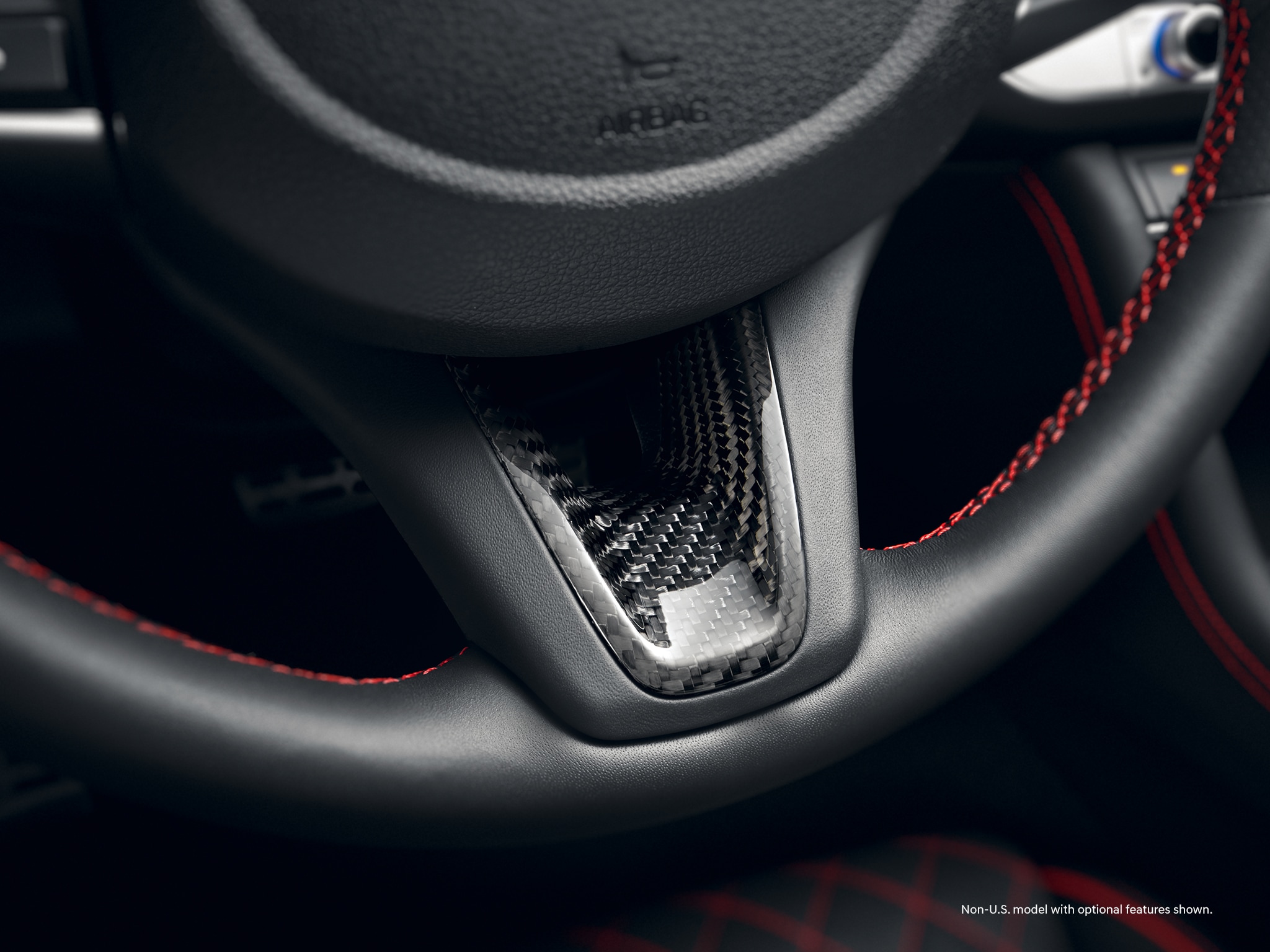 2022 Genesis G70’s available three-spoke sport steering wheel with carbon fiber trim.