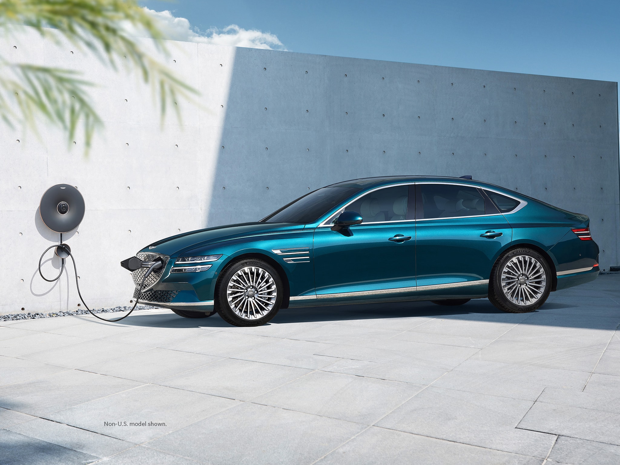 2023 Electrified G80 exterior shown in Matira Blue charging