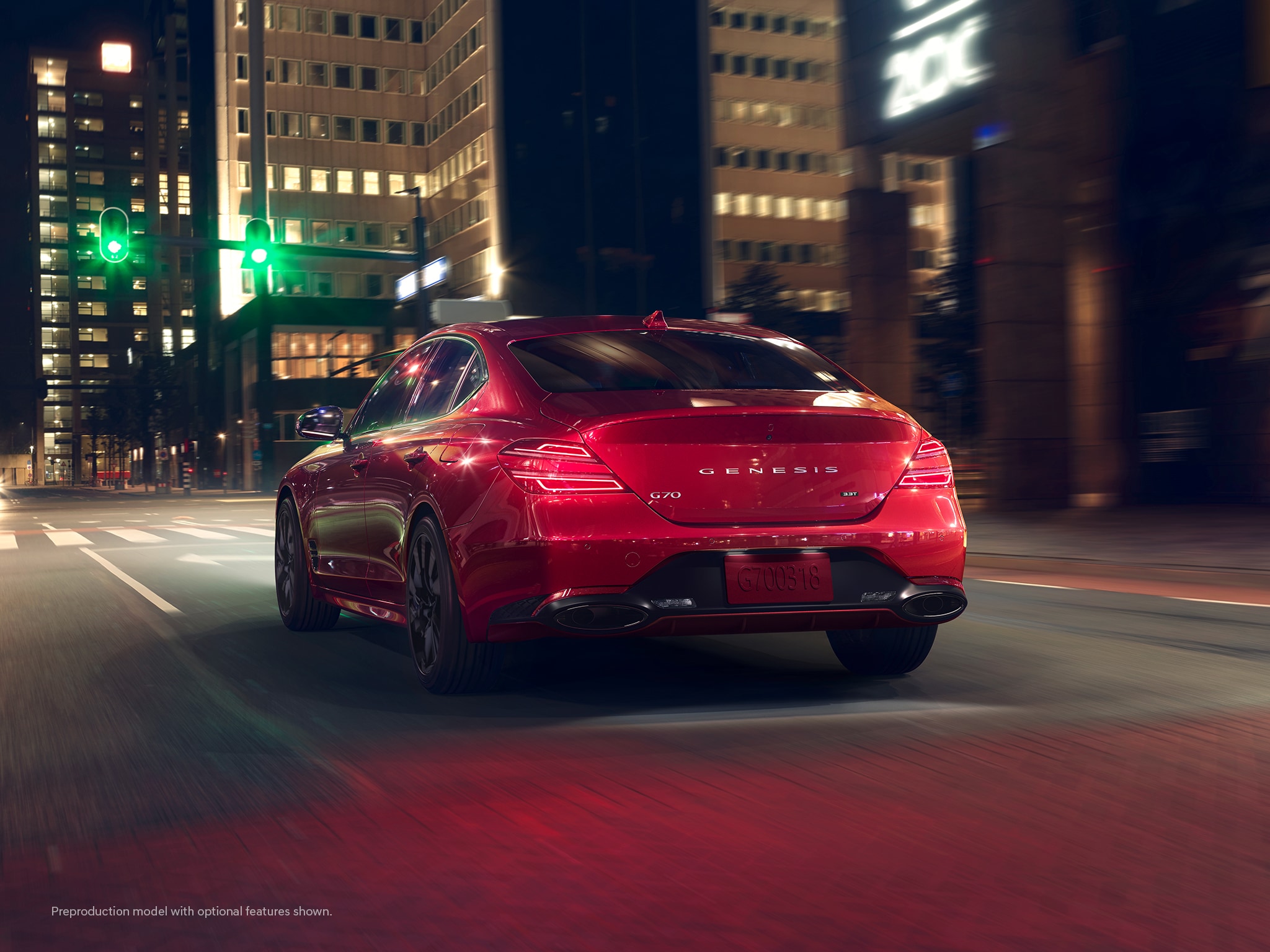 2023 Genesis G70 shown in city at night.