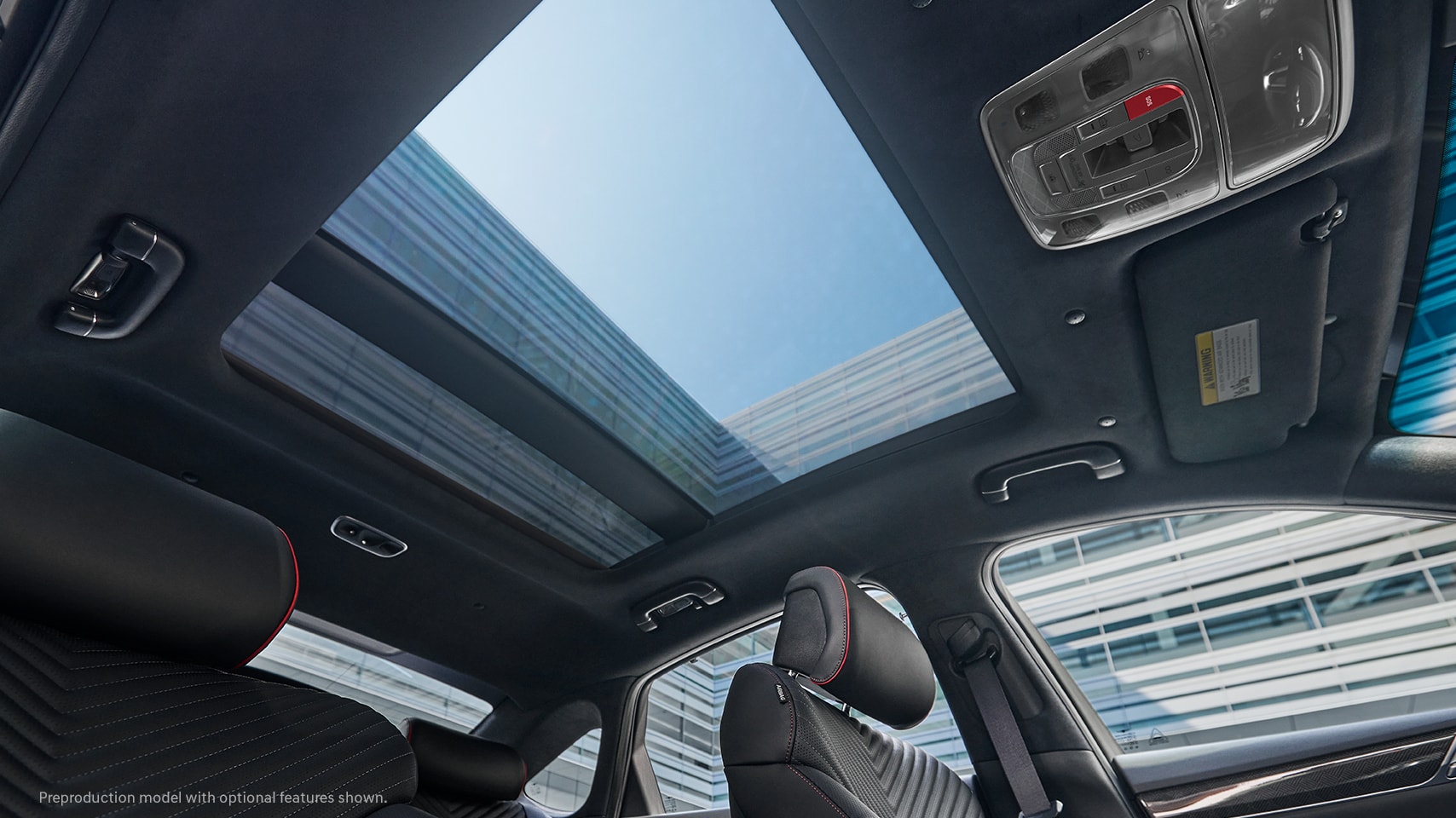 2023 Genesis G80 interior with open panoramic sunroof.