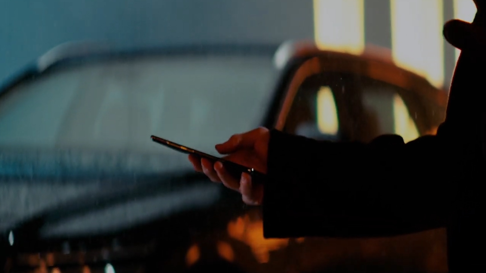 Genesis owner holding smartphone using Genesis Digital Key.