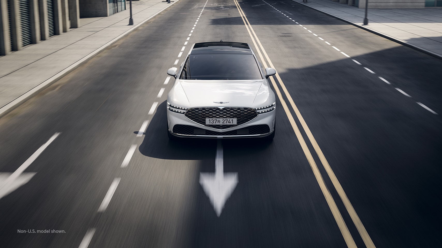 2023 Genesis G90 shown on road within lane.