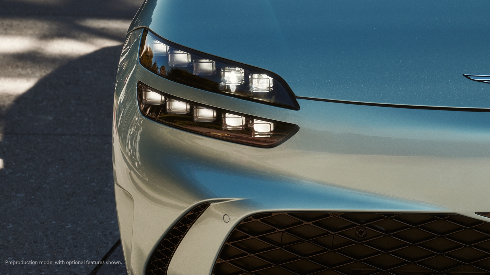 2023 Genesis GV60 shown with illuminated Two Lines headlamps.