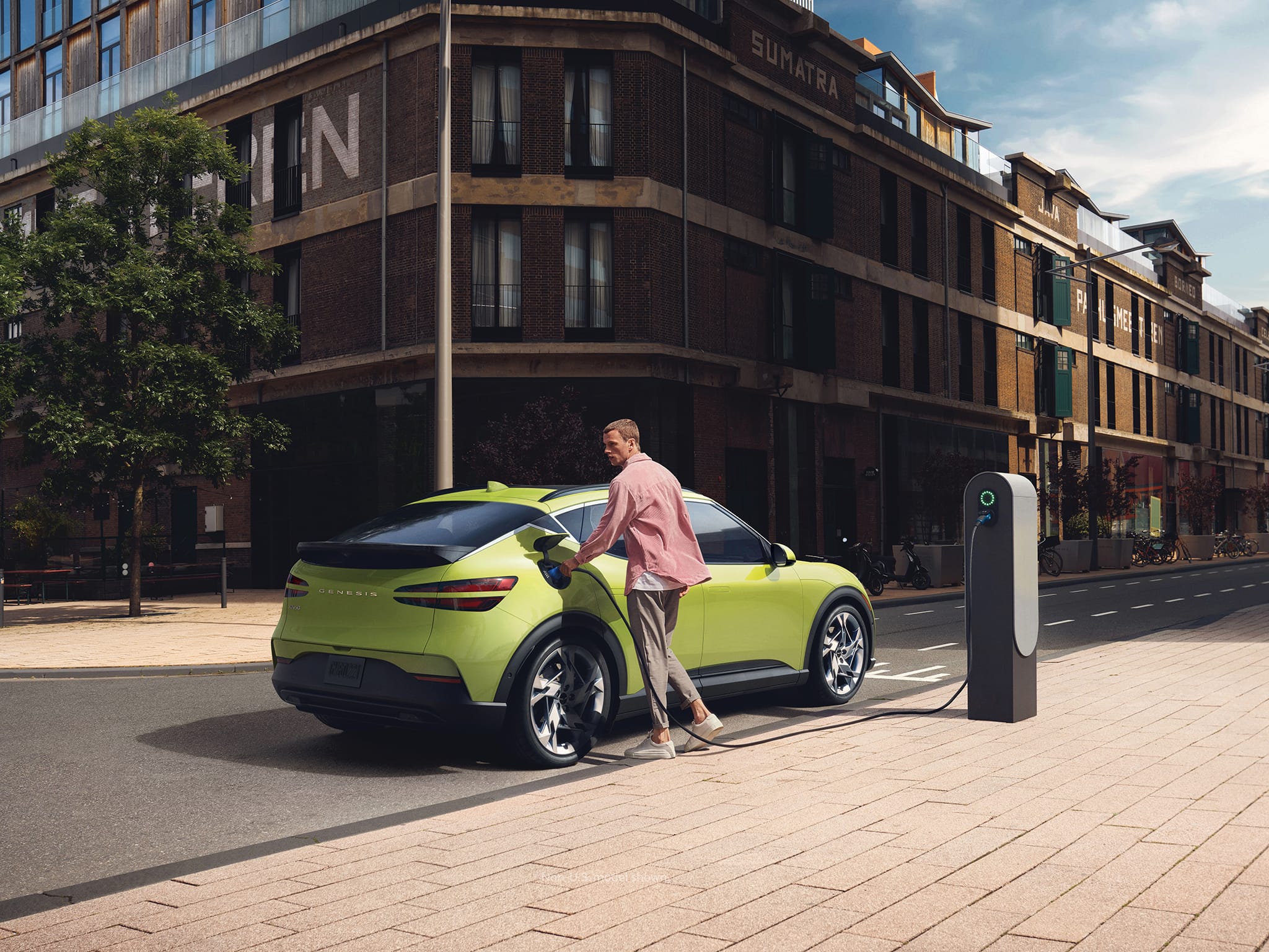 2023 Genesis GV60 in Sao Paulo Lime at electric charging station.