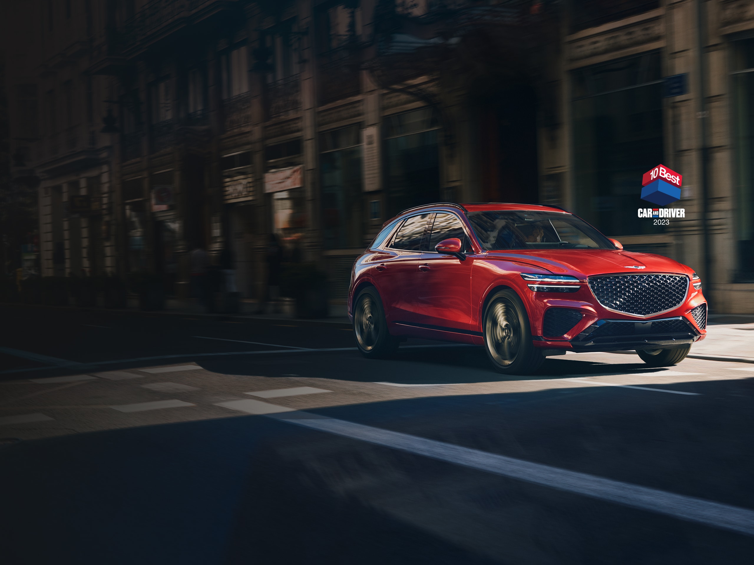 2023 Genesis GV70 shown in Mauna Red.